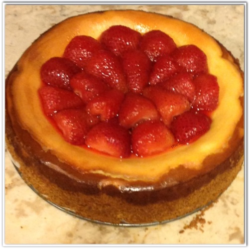 Using the strawberries you had set aside to cool, cover the top of the cheesecake. 